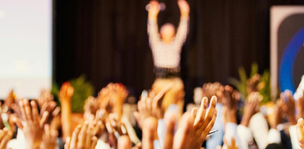 crowd raising hands